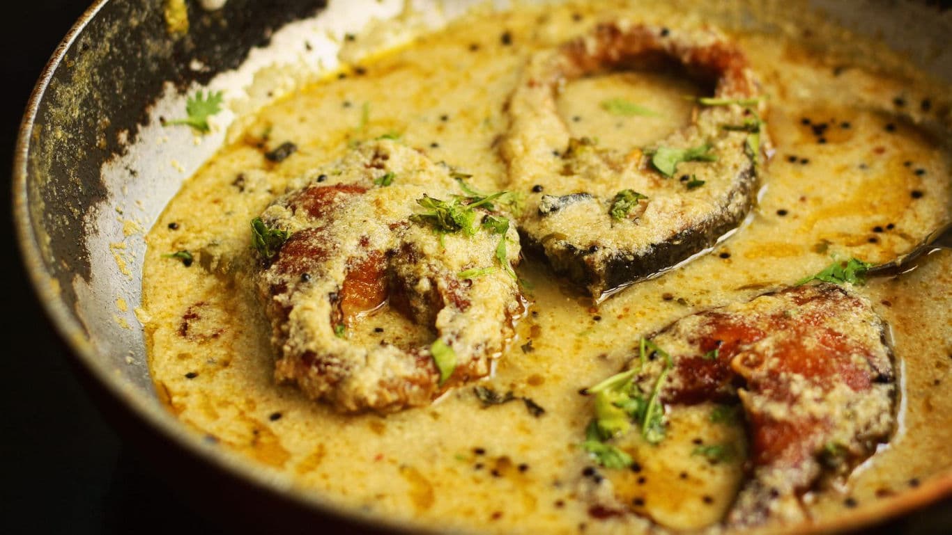 Fish curry simmering in creamy spiced gravy