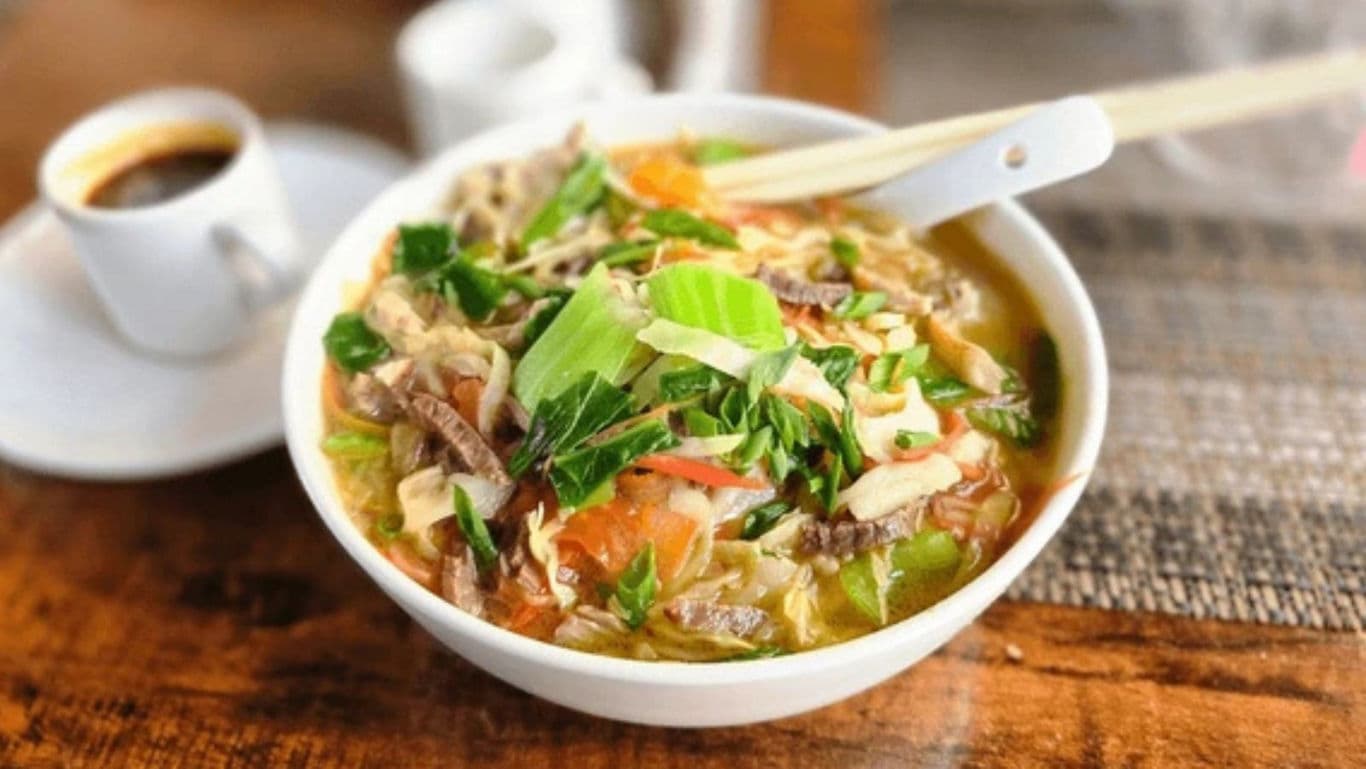 Bowl of Vietnamese noodle soup with herbs