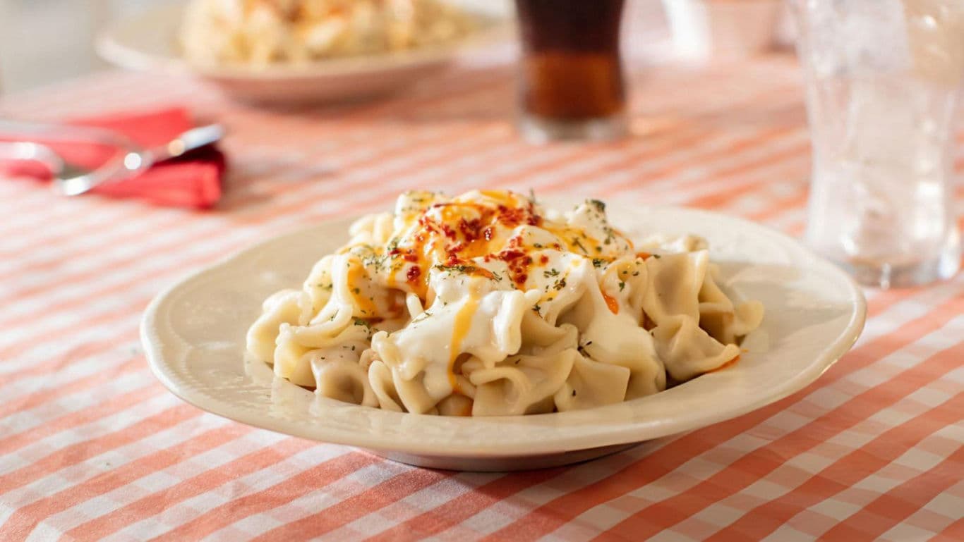 Creamy pasta dish on checkered tablecloth