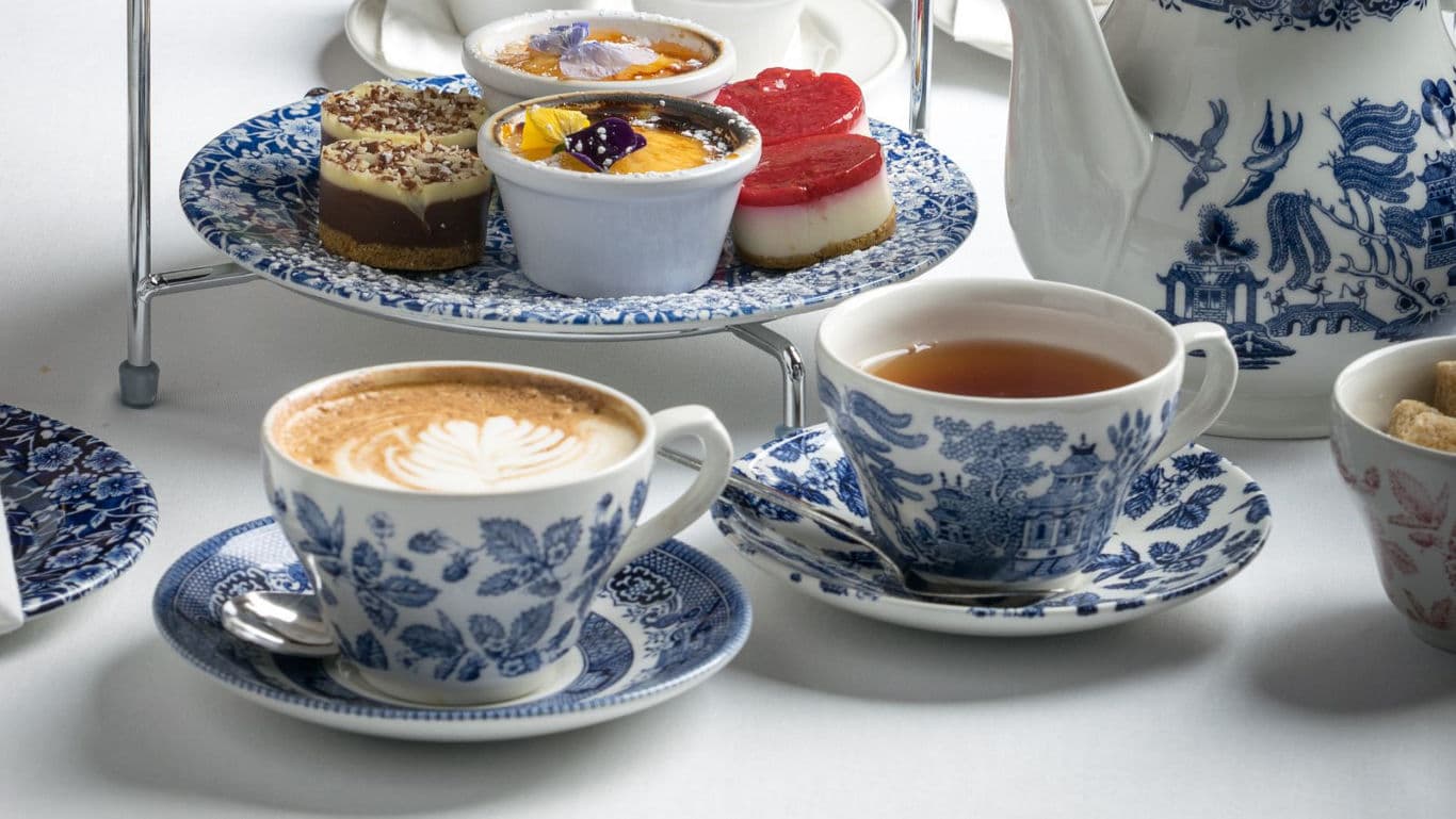 Elegant afternoon tea with coffee and desserts