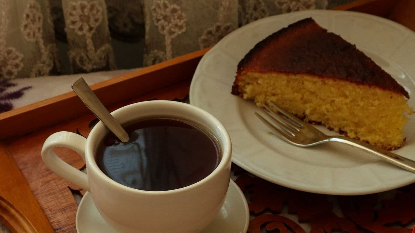 Cup of hot tea with slice of cake
