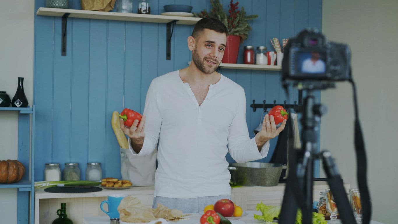 Food vlogger recording cooking tutorial at home