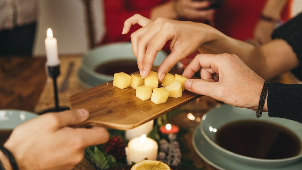 Friends sharing cheese cubes
