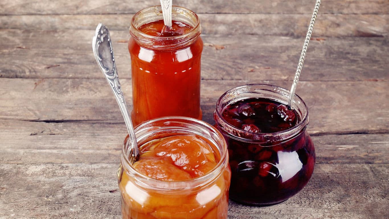 Assorted fruit jams in glass jars
