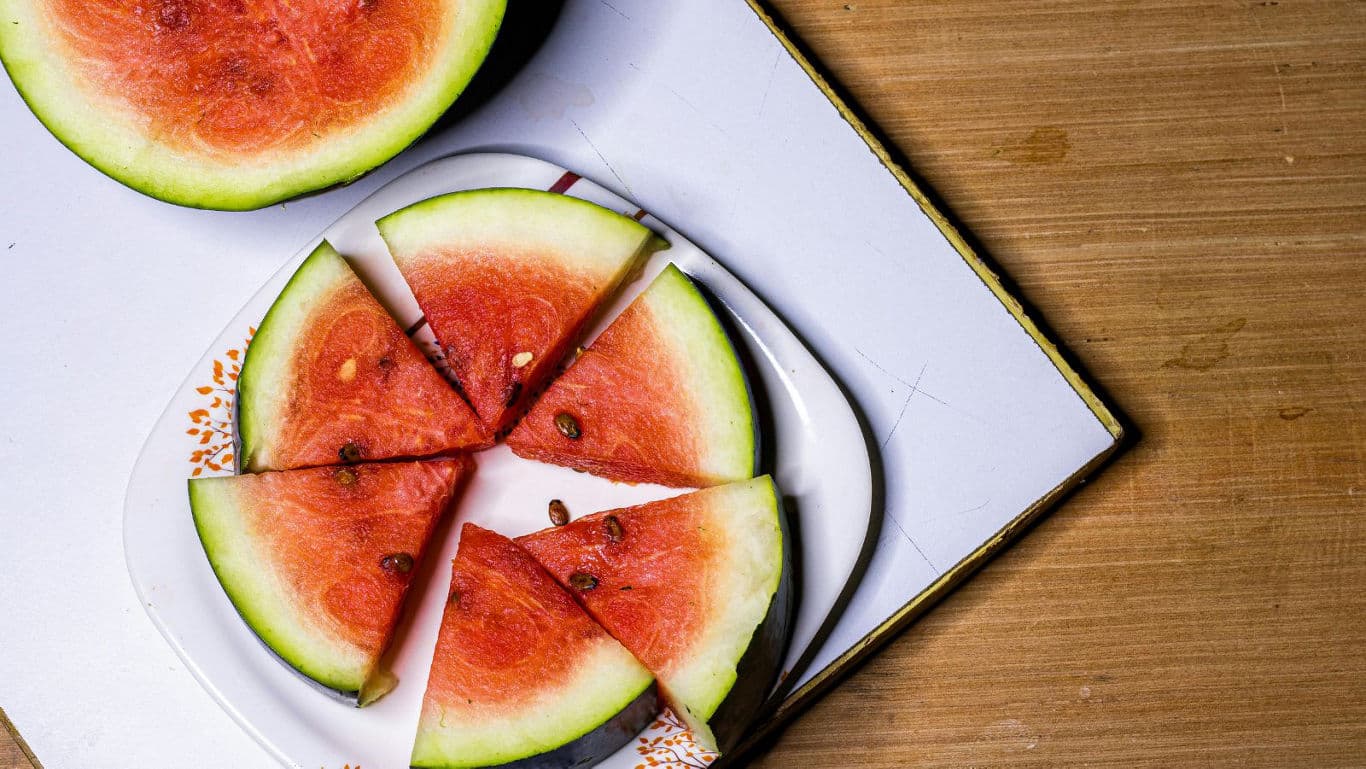 Sliced watermelon wedges on white plate