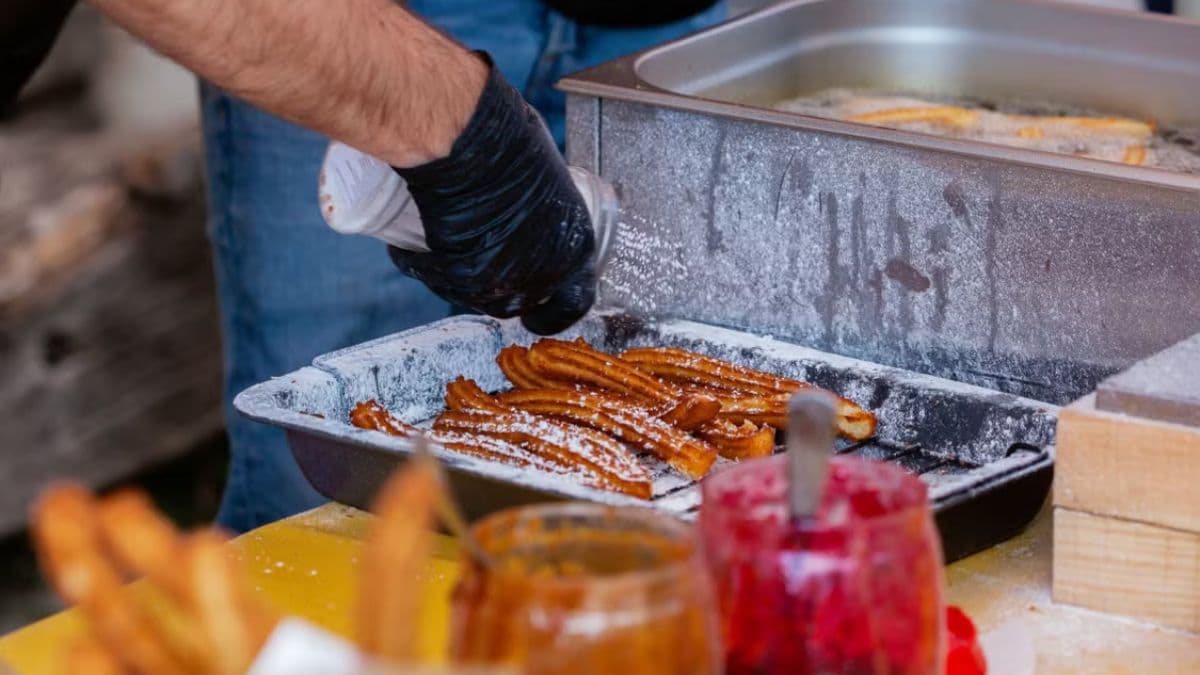 churros being coated with sugar