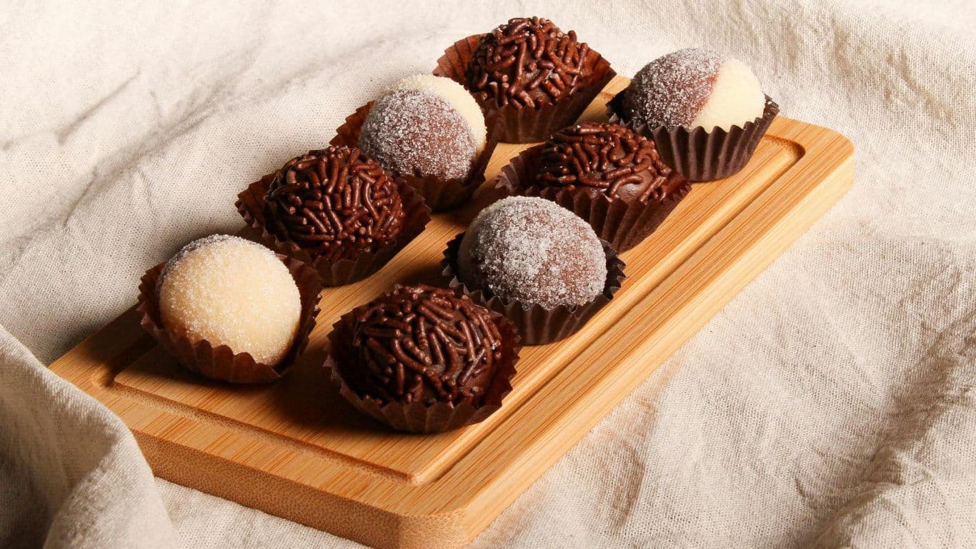 Assorted chocolate truffles on wooden board