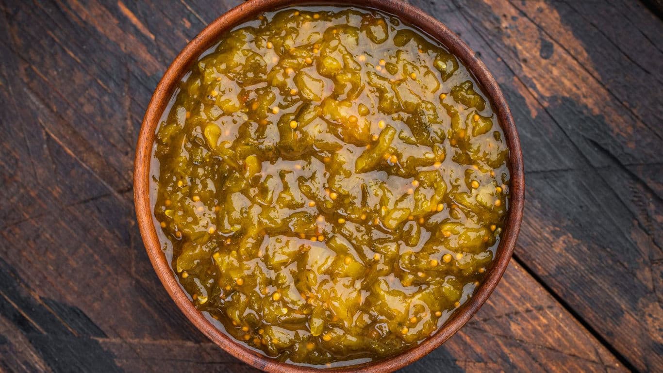 Bowl of chunky green relish on wood