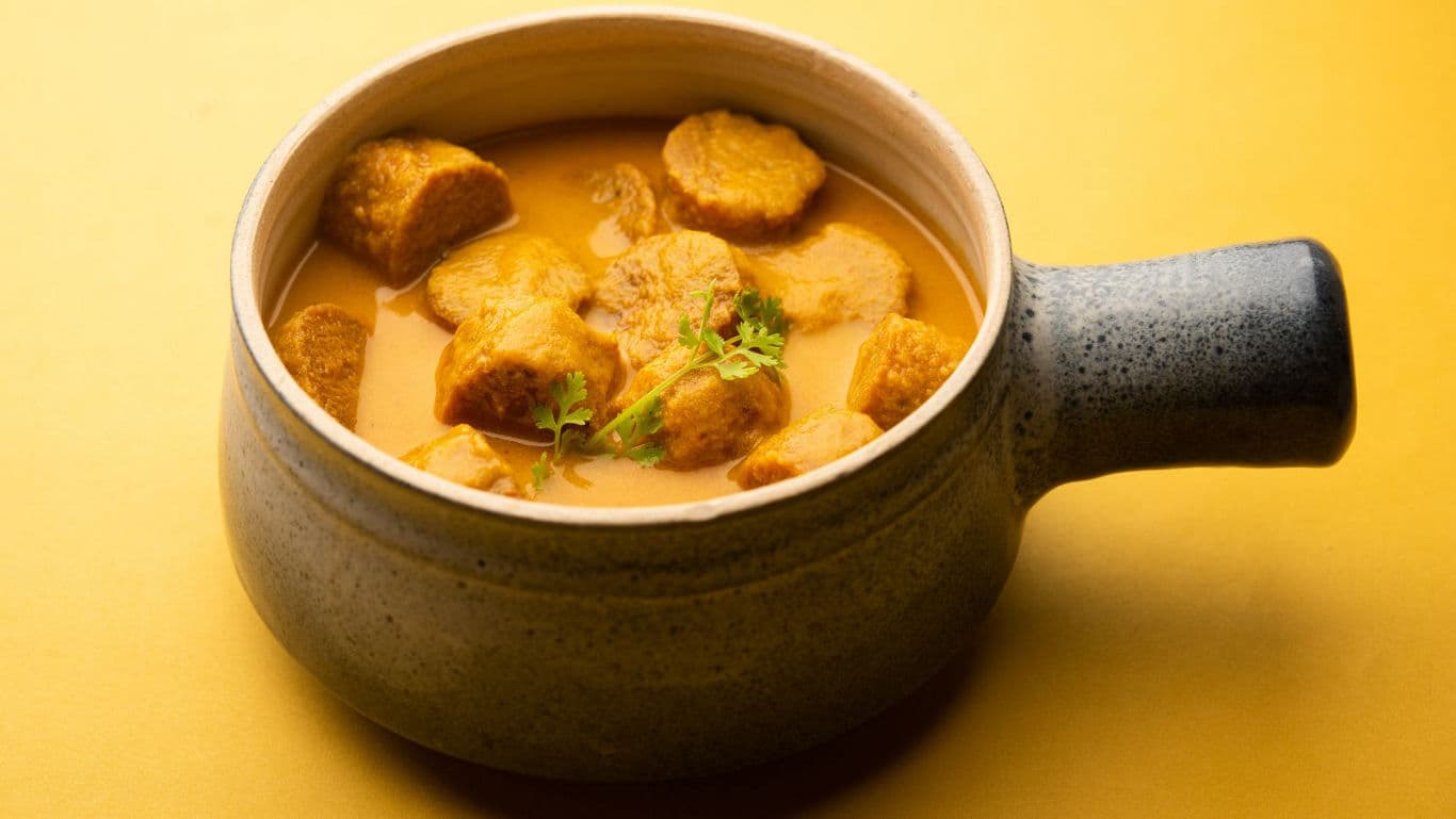 Creamy soup with croutons in ceramic mug