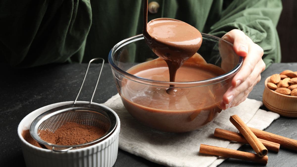 melted chocolate in a bowl with powder on the side
