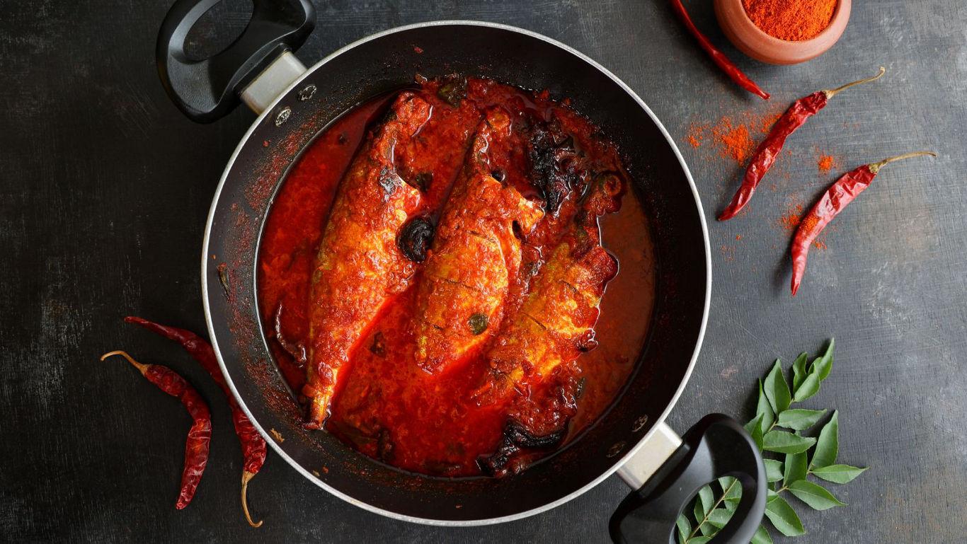 Spicy fish curry in black pan