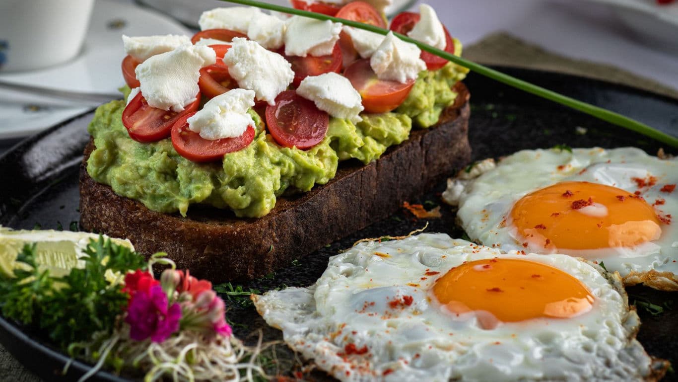 Gourmet avocado toast with fried eggs