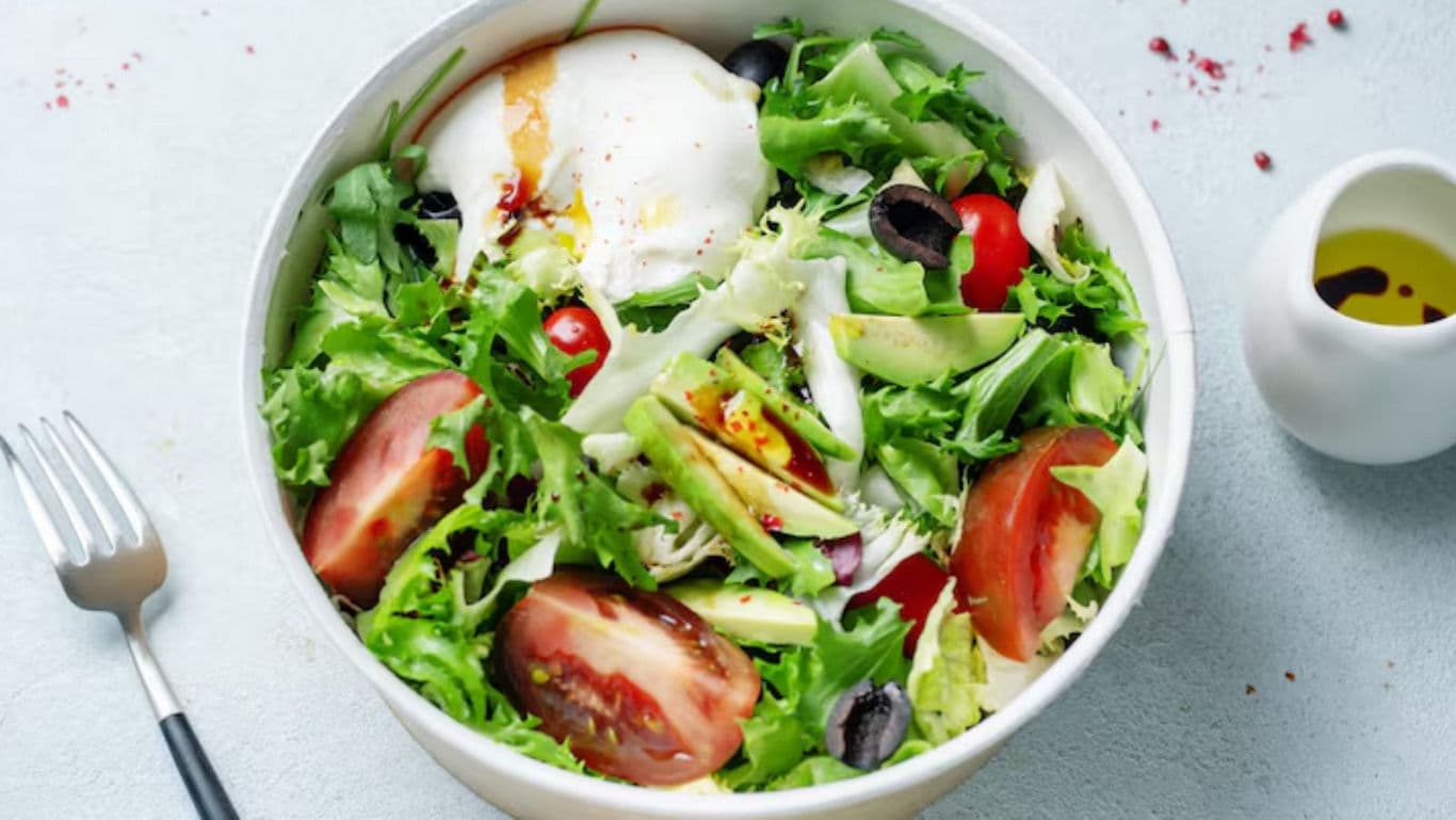 Fresh green salad with tomatoes and poached egg