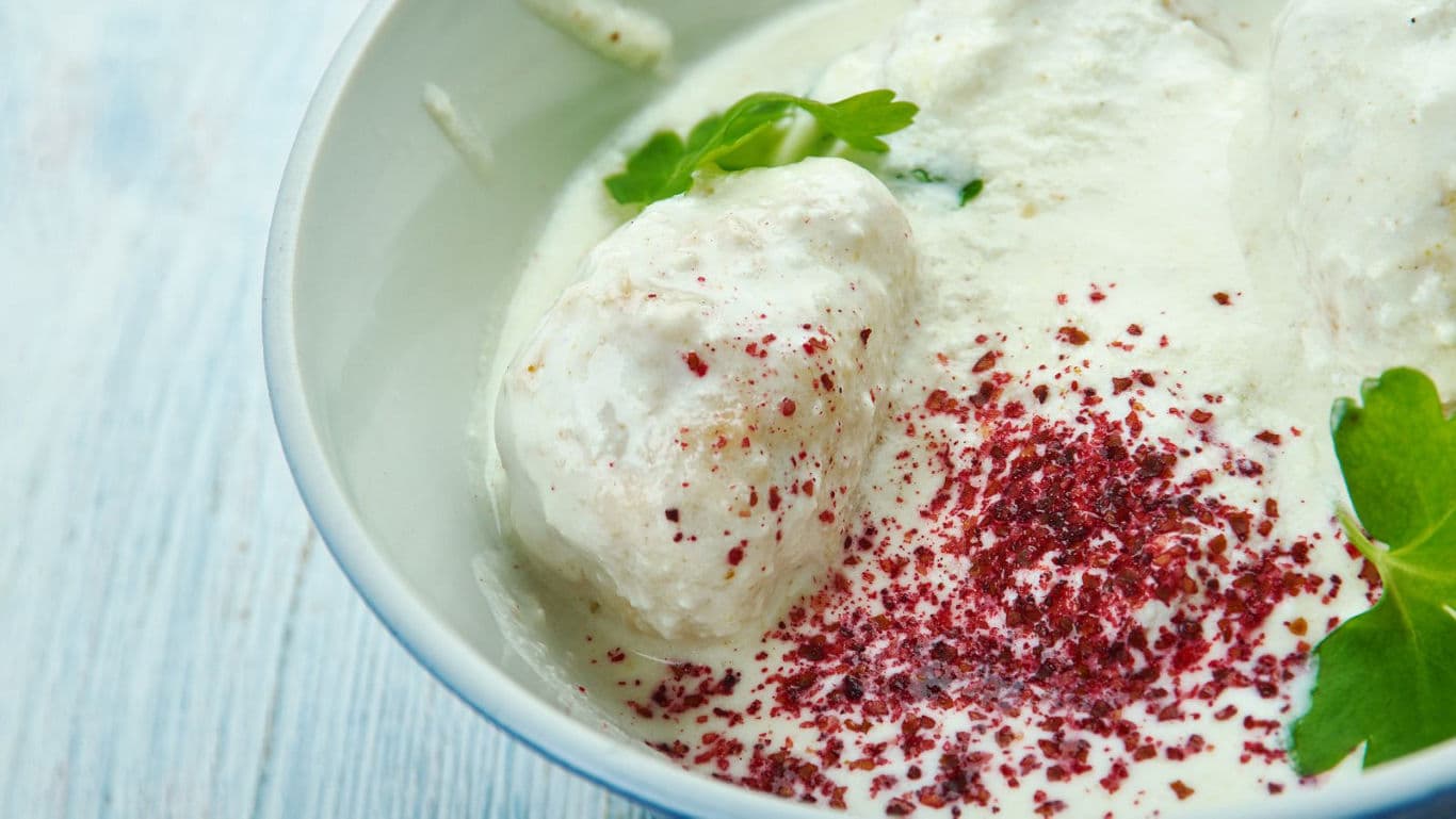 Traditional yogurt curry with dumplings and herbs