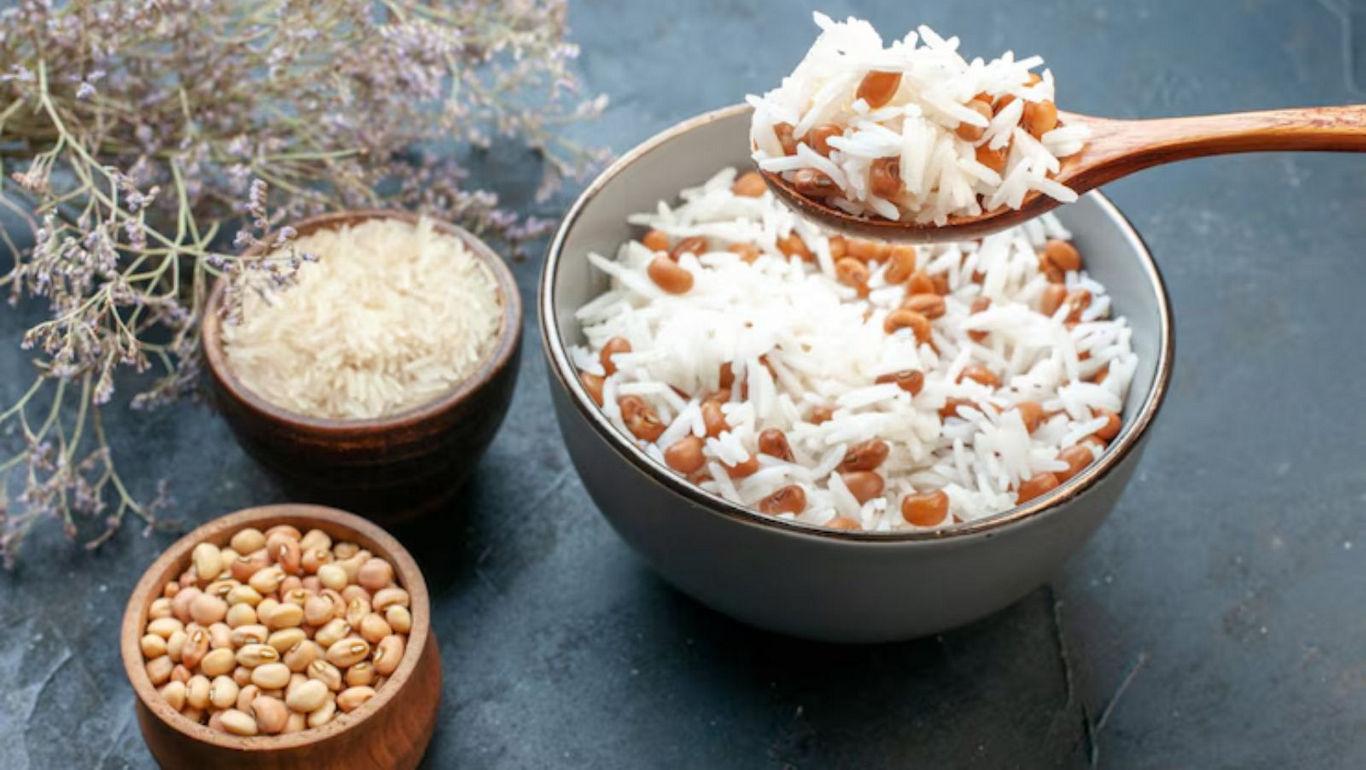 Bowl of rice and beans with wooden spoon