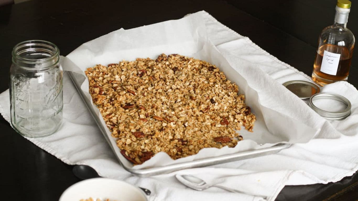 Homemade Granola on Baking Sheet with Jars