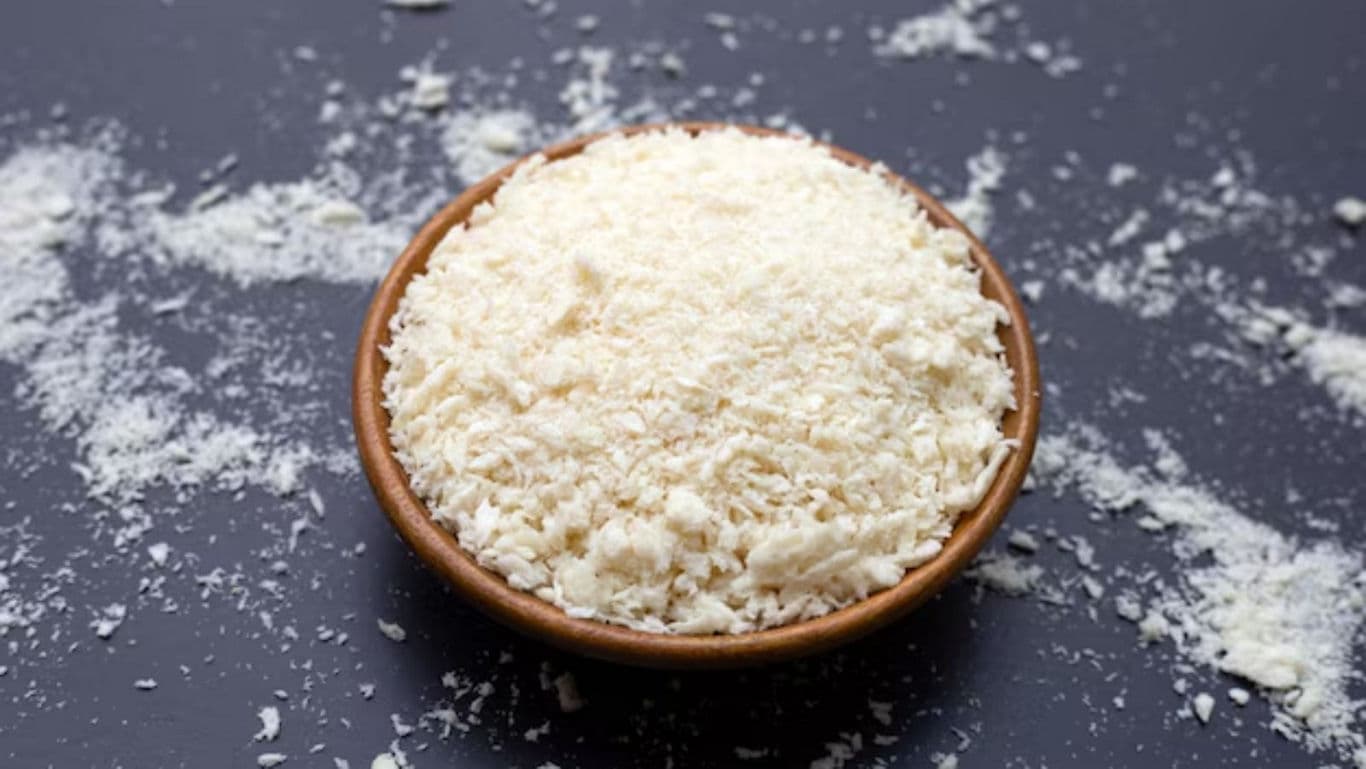 Wooden bowl of shredded white cheese