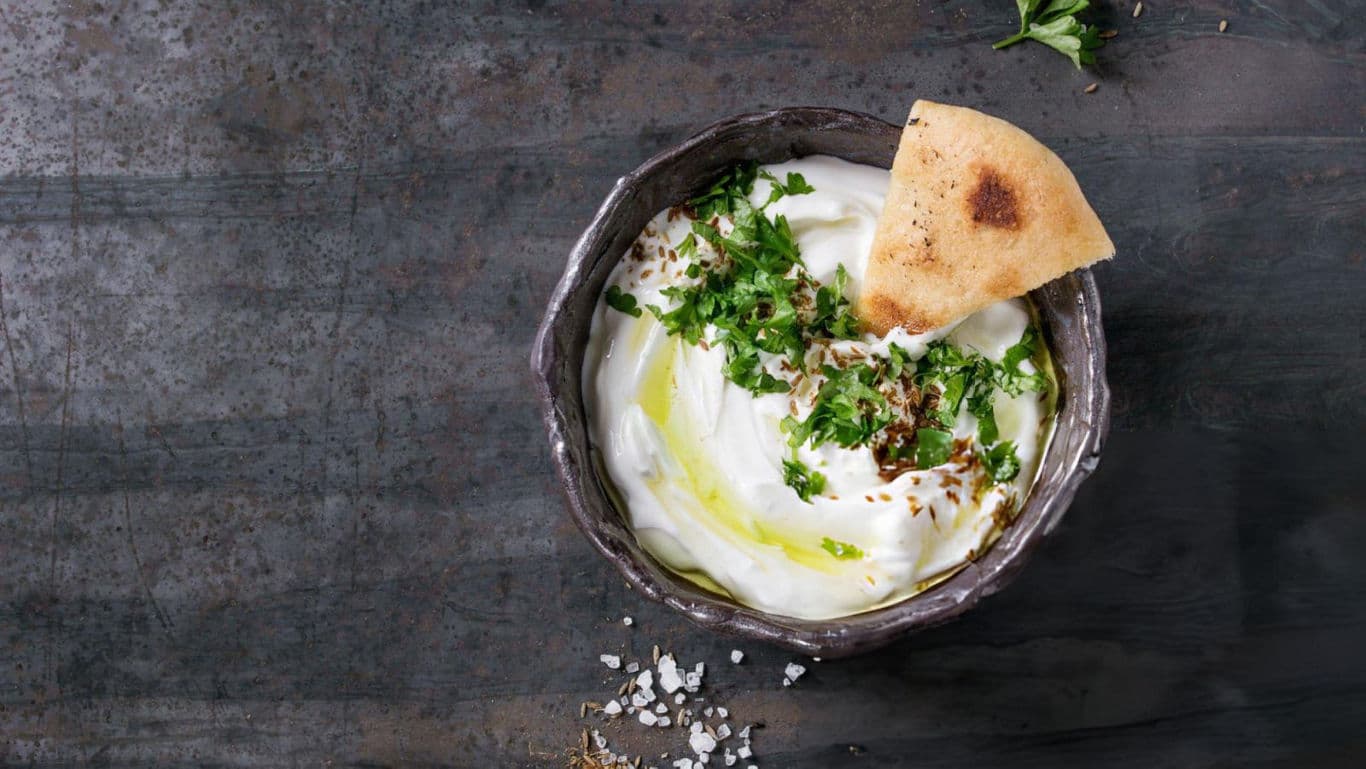 Bowl of creamy yogurt with herbs