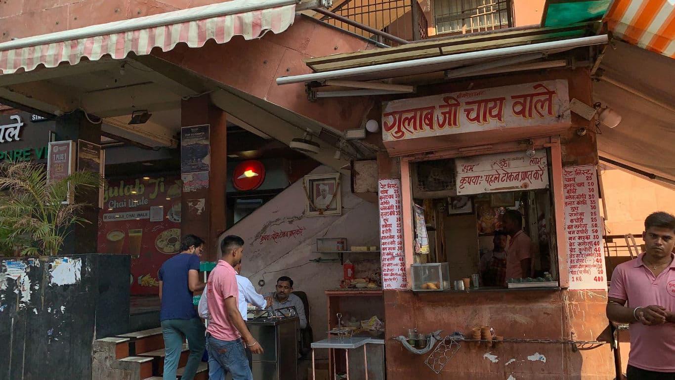 Street Tea Stall with Customers in Urban Setting