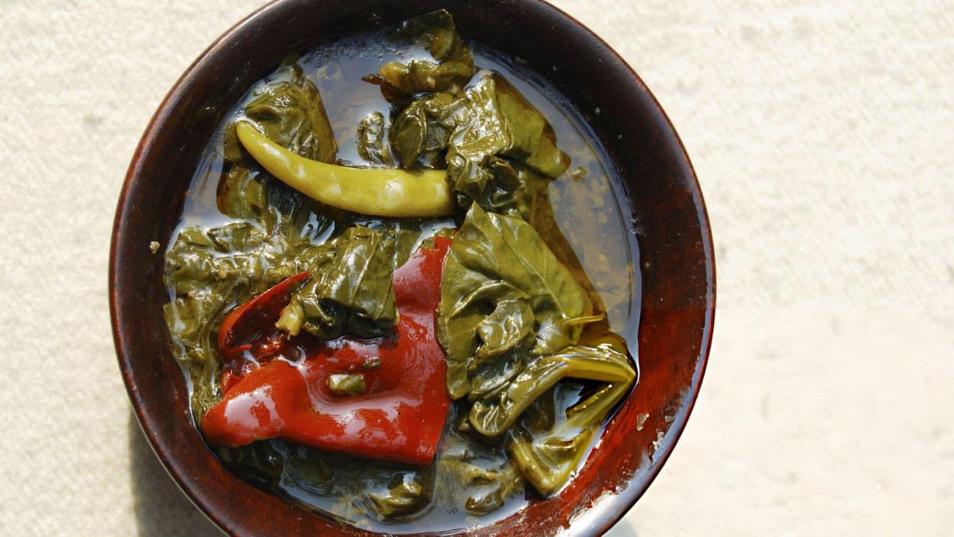 Bowl of pickled green and red chili peppers