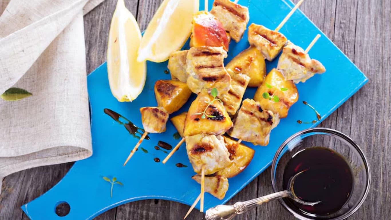 Grilled Chicken and Pineapple Skewers with Lemon Wedges