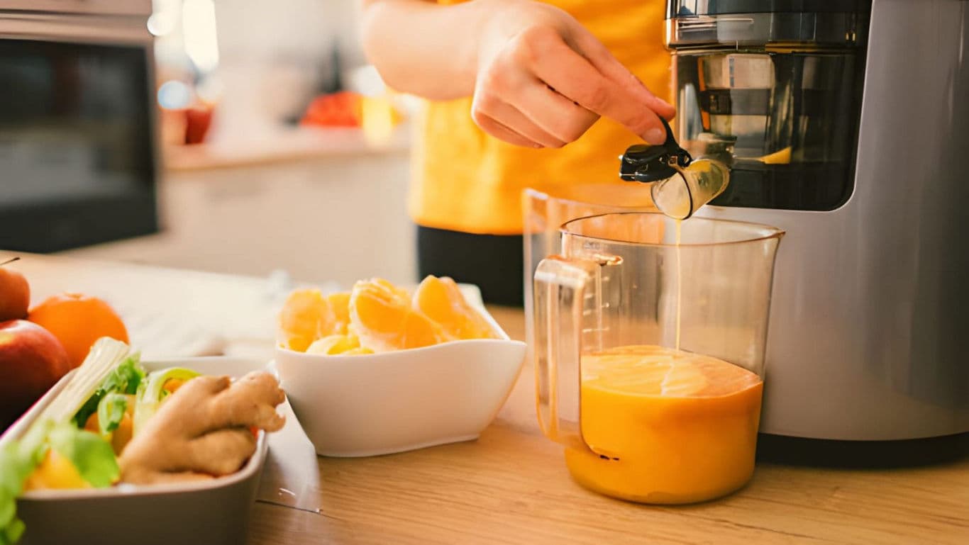 Fresh orange juice preparation in kitchen