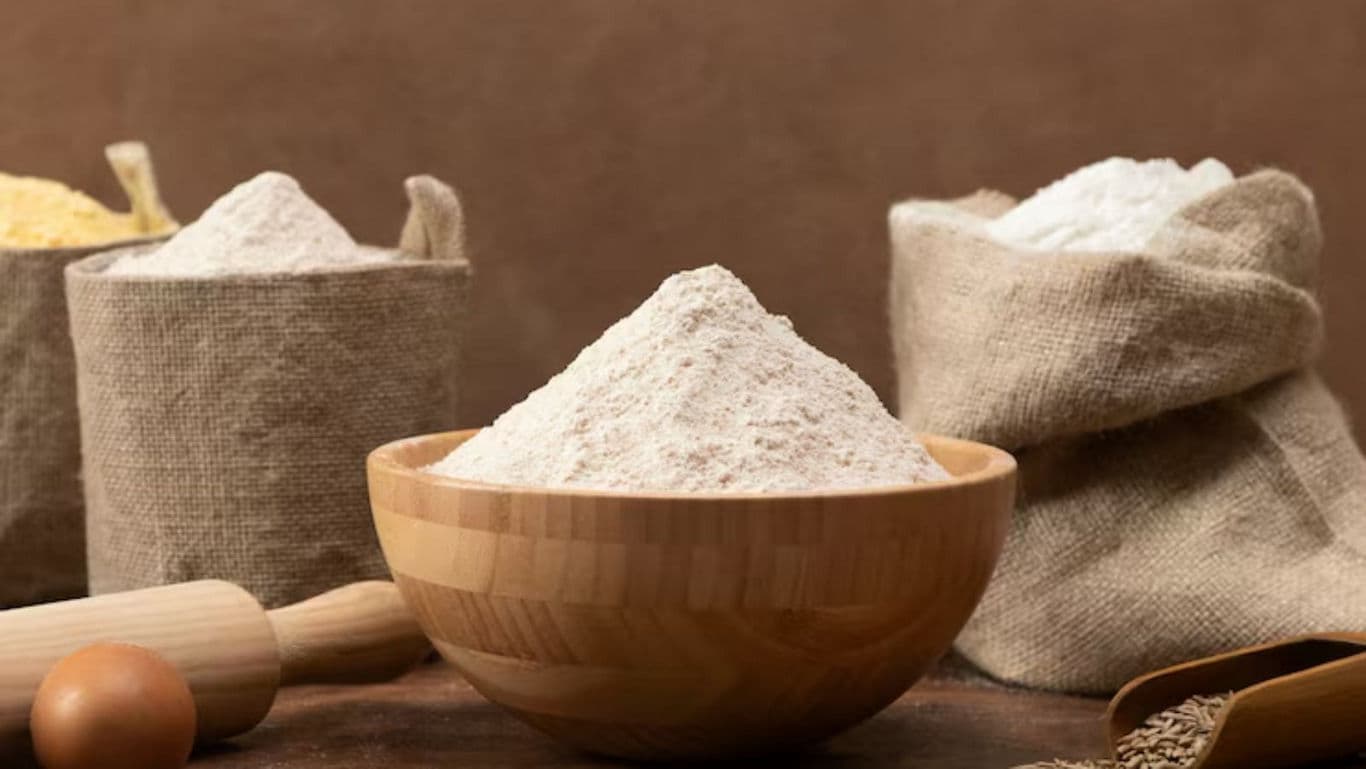 Assorted flours in wooden bowl and burlap sacks