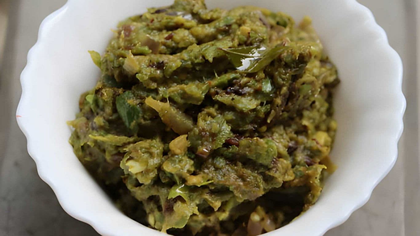 Green chili chutney served in white ceramic bowl