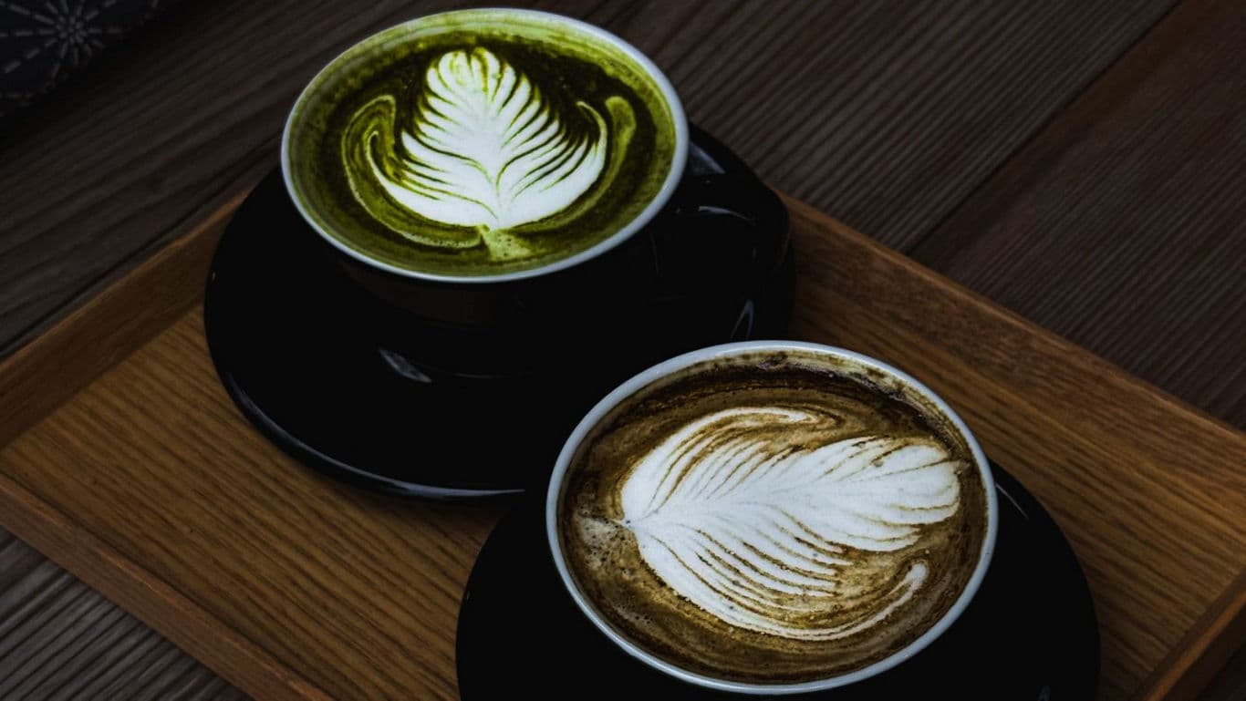 Two artisan lattes with leaf latte art