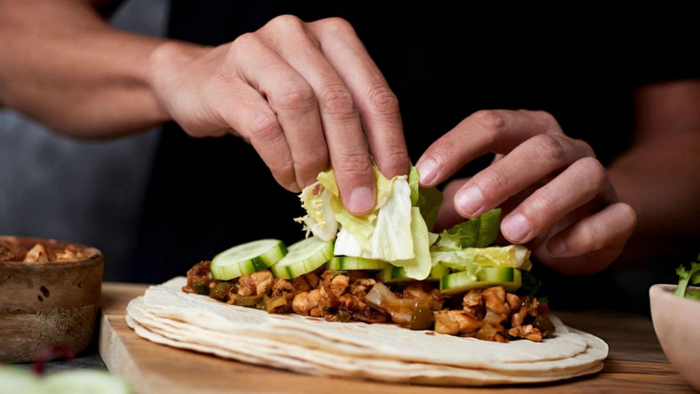 Hands Preparing Fresh Vegetable Wrap