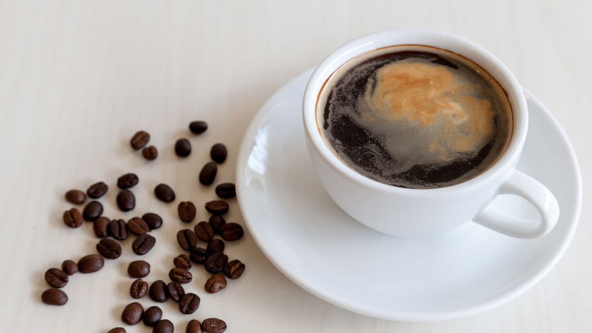 a cup of Americano with beans on the side