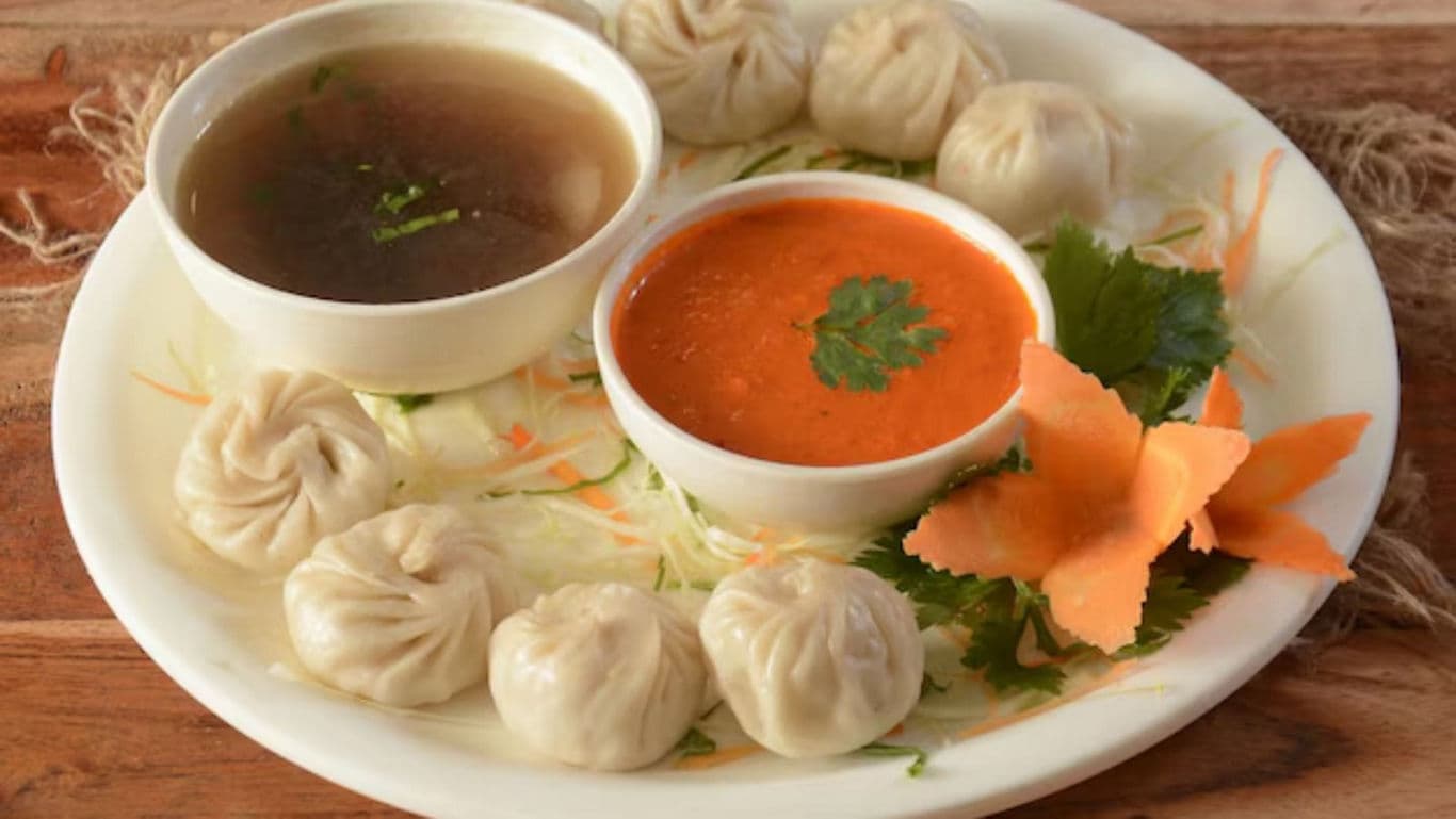 Steamed dumplings with sauces on plate