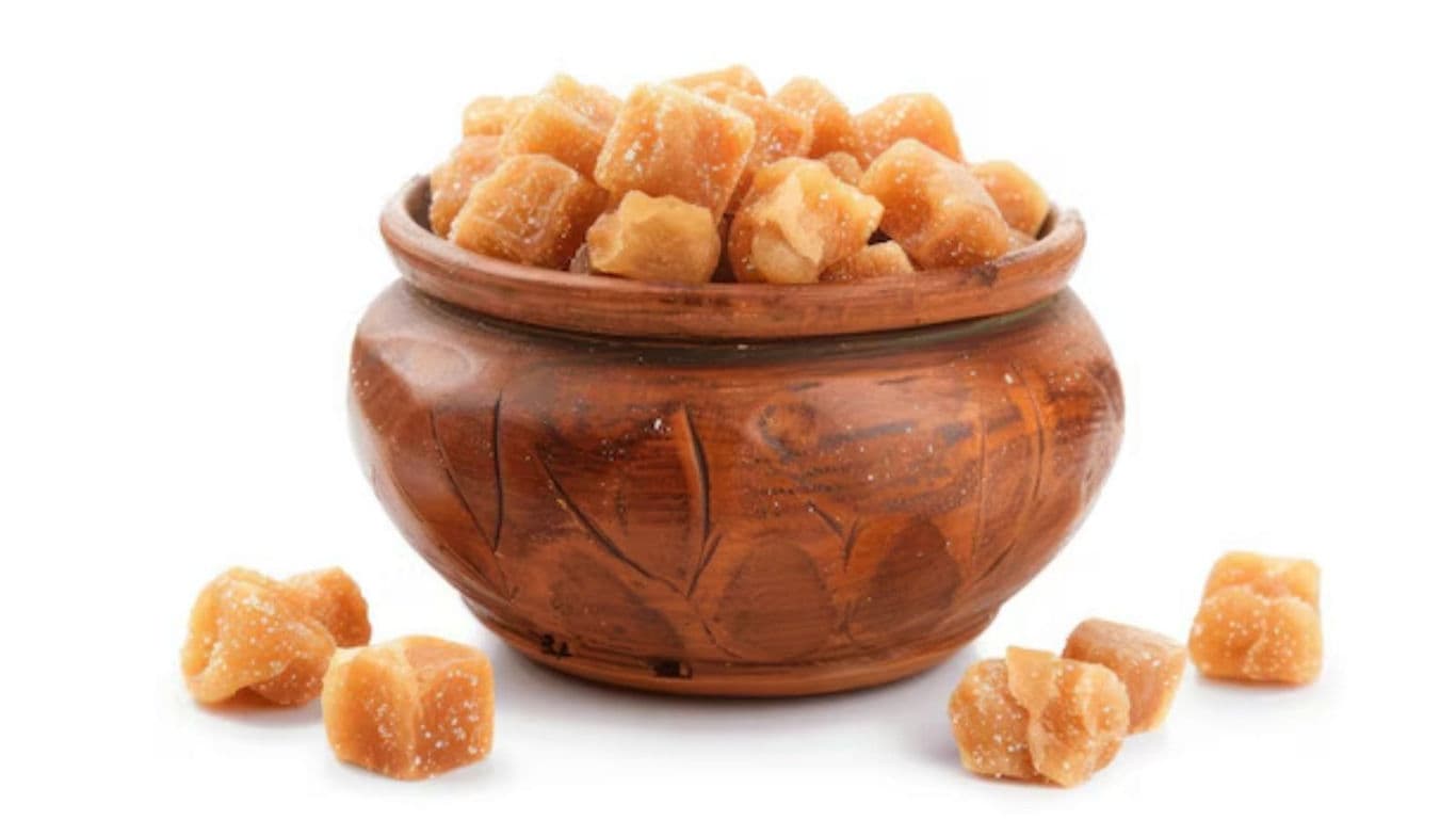 Brown sugar cubes in carved wooden bowl