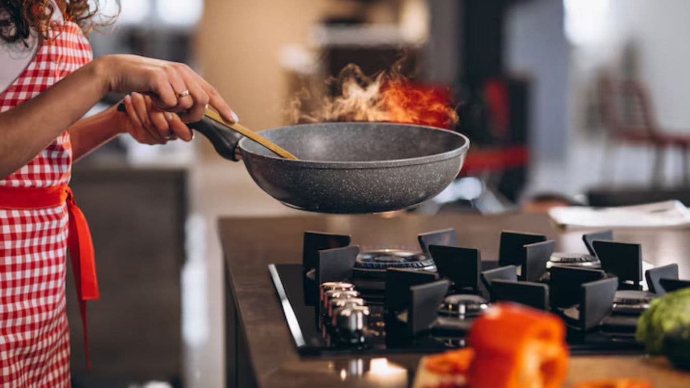 Cooking with frying pan on gas stove