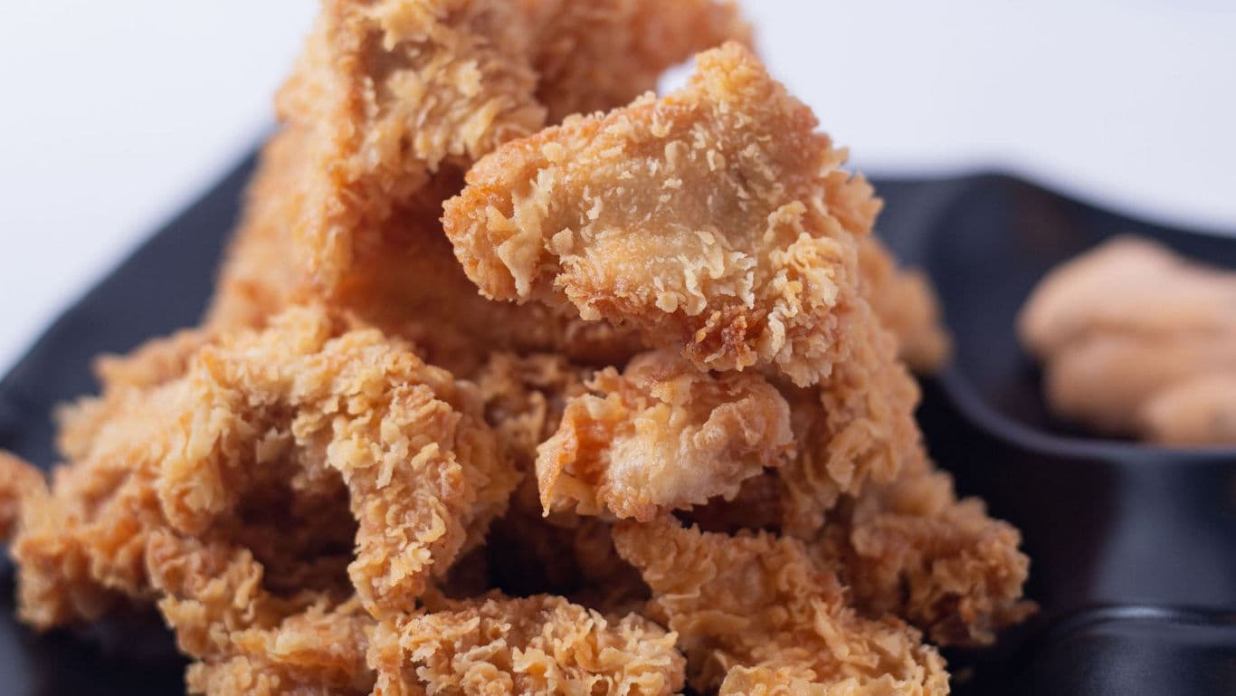 Crispy golden fried chicken strips closeup