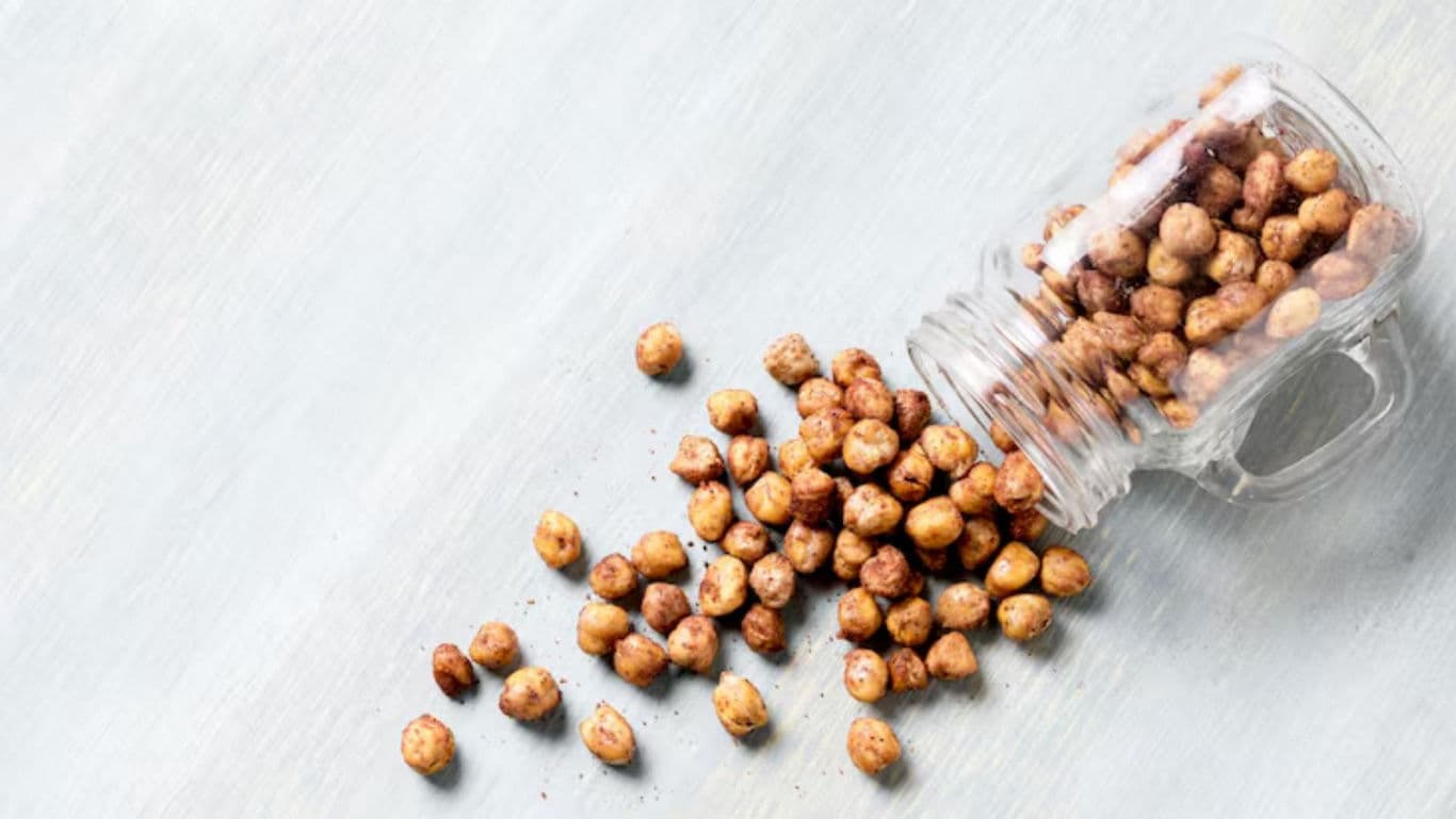 Spilled roasted chickpeas in glass jar