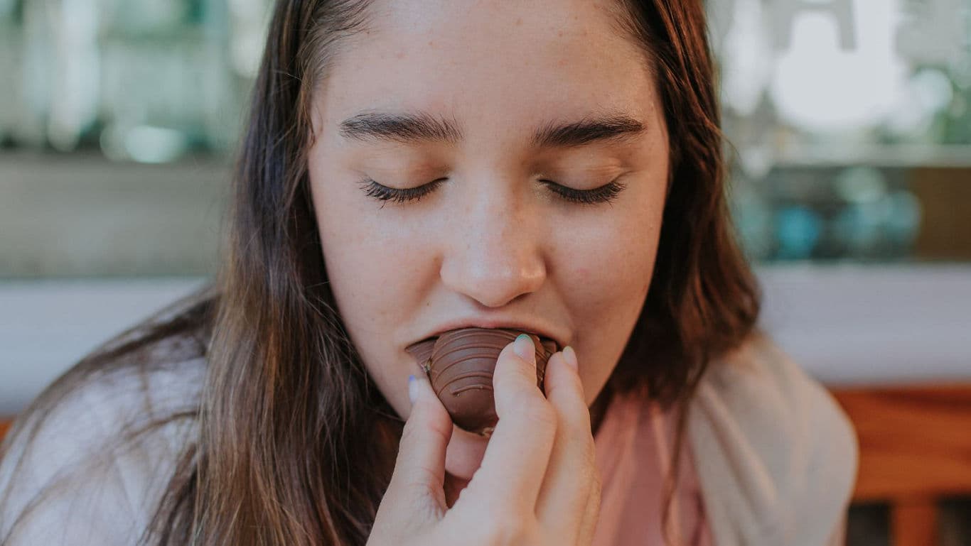 Young woman savoring chocolate treat