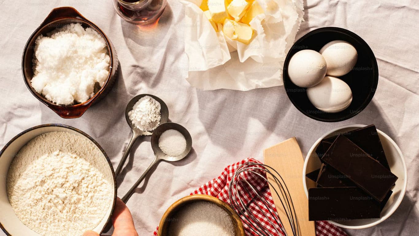 Baking ingredients arranged on kitchen table