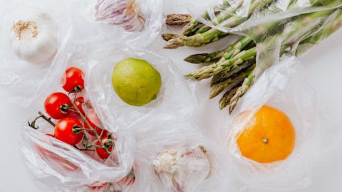 Fresh Produce in Plastic Bags on White Surface