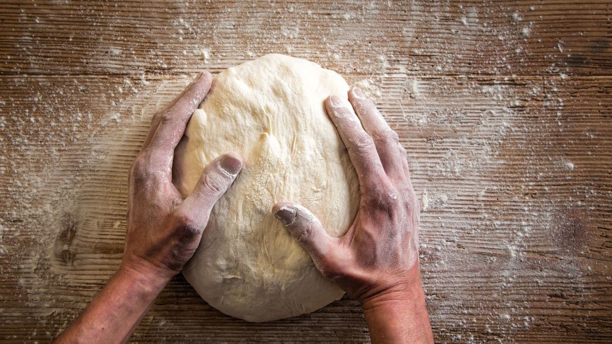 Person holding dough