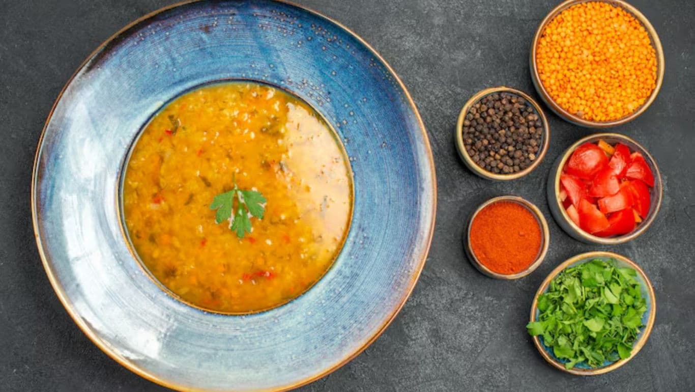 Lentil soup with fresh herbs and spices overhead