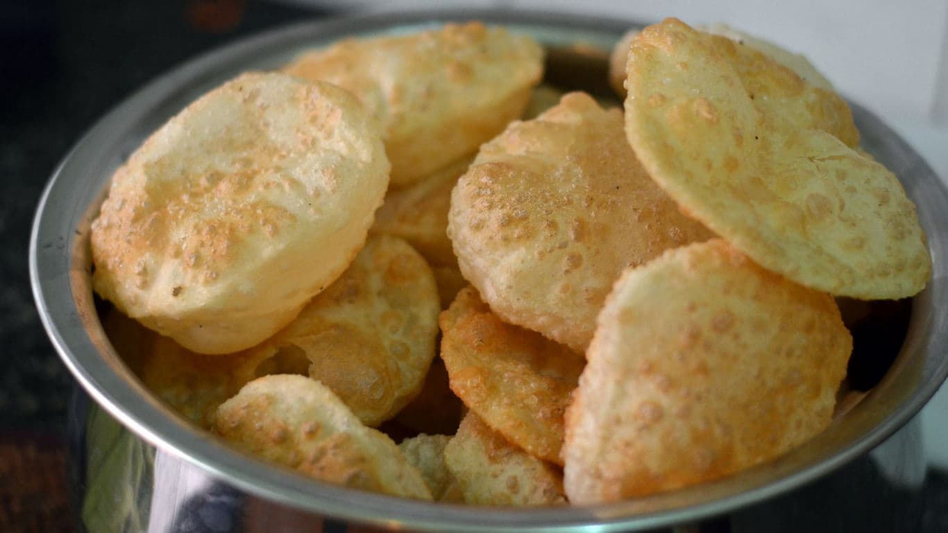 Freshly fried Indian puri bread stack