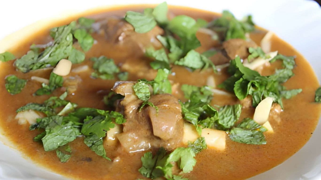 Spicy curry dish garnished with fresh herbs