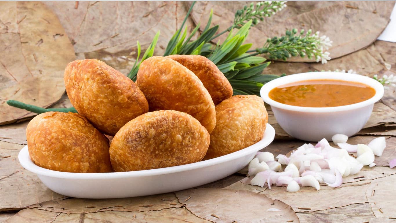 Crispy fried snacks served with curry dip