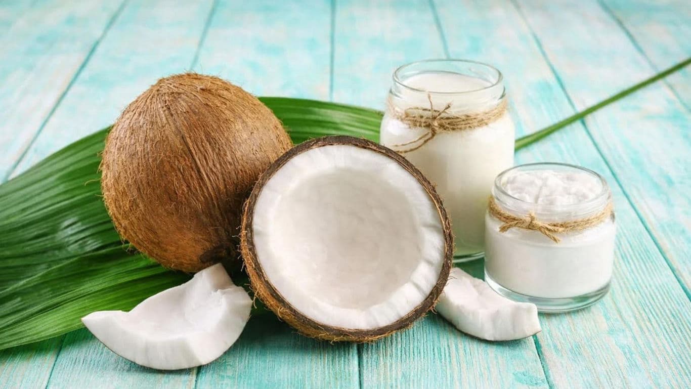 Fresh coconuts with jars of coconut cream