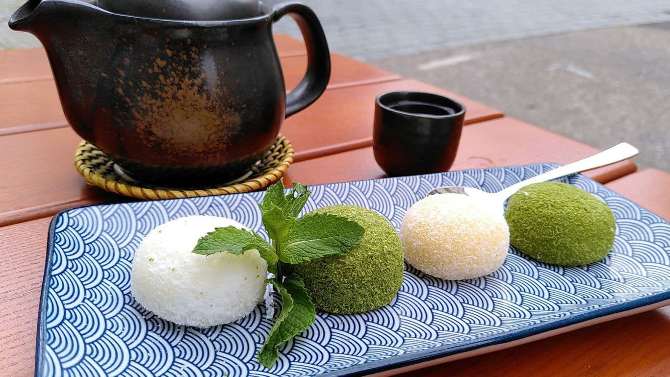 Colorful mochi dessert with traditional tea