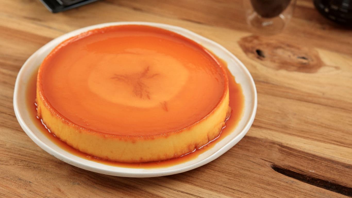 Caramel flan dessert on wooden table