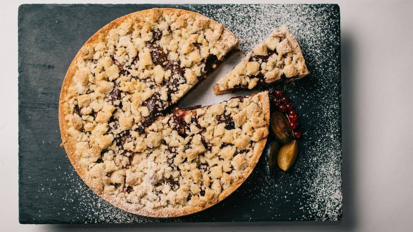 Crumble topped fruit tart on slate board