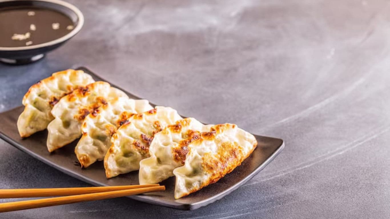Pan-fried dumplings with dipping sauce