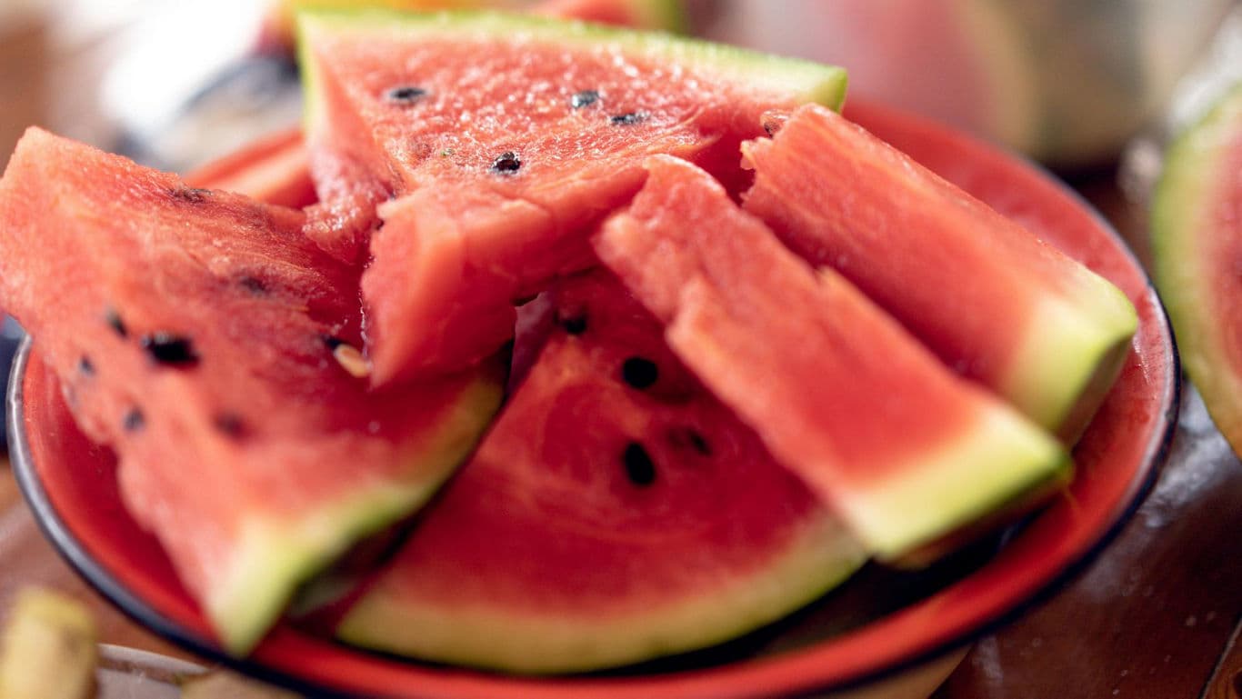 Fresh watermelon slices on red plate